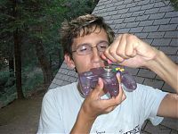 man smoking weed from a nintendo 64 controller